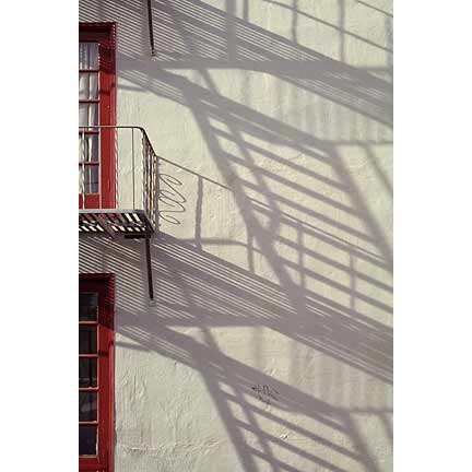 Urban photography, stair shadows on wall.